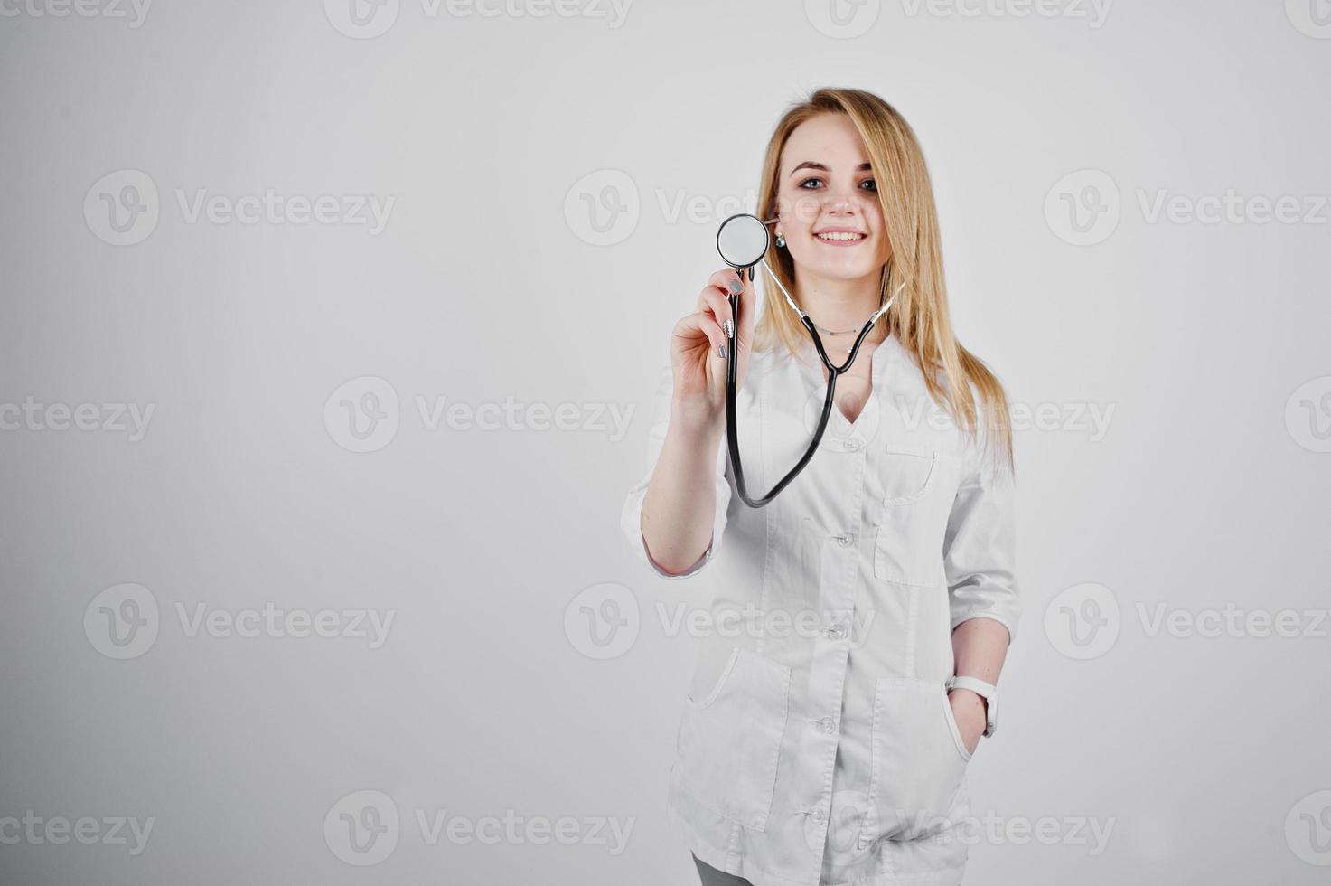 Blonde doctor nurse with stethoscope isolated on white background. photo