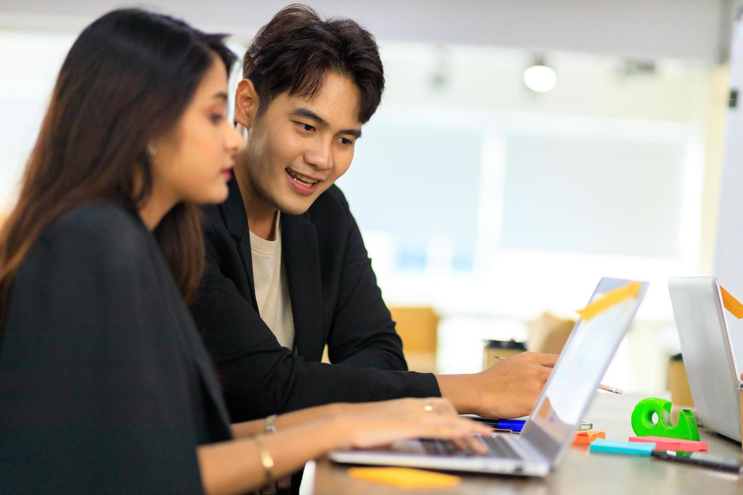 Two business people discussing working with a young Indian female worker on a project, people holding a video meeting with a client or interviewing a job candidate. photo