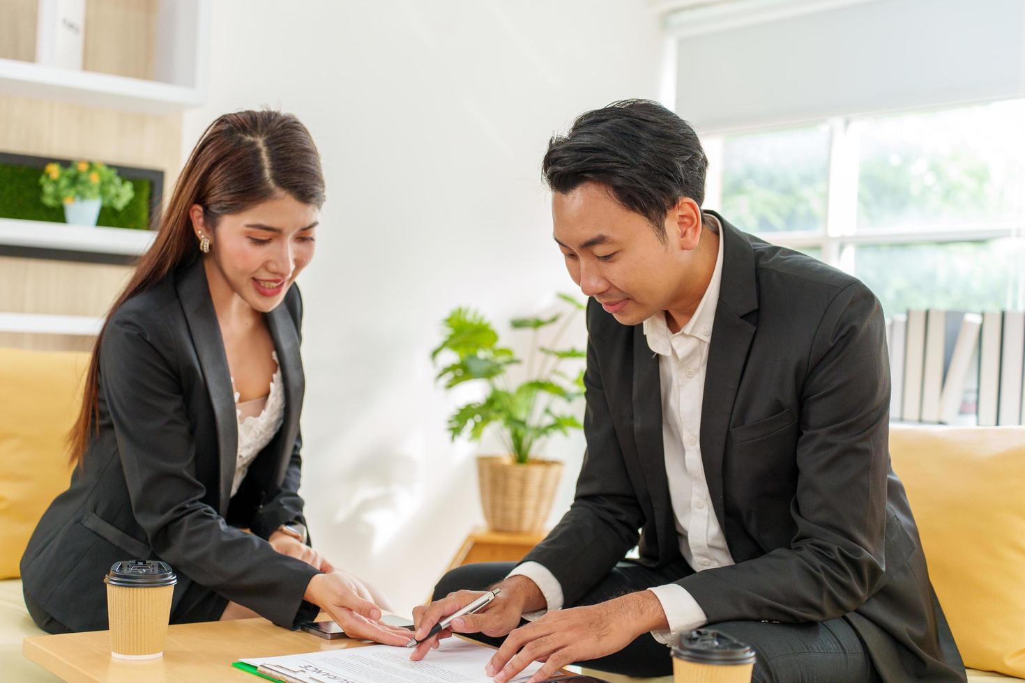 Two business people discussing working with a young Indian female worker on a project, people holding a video meeting with a client or interviewing a job candidate. photo