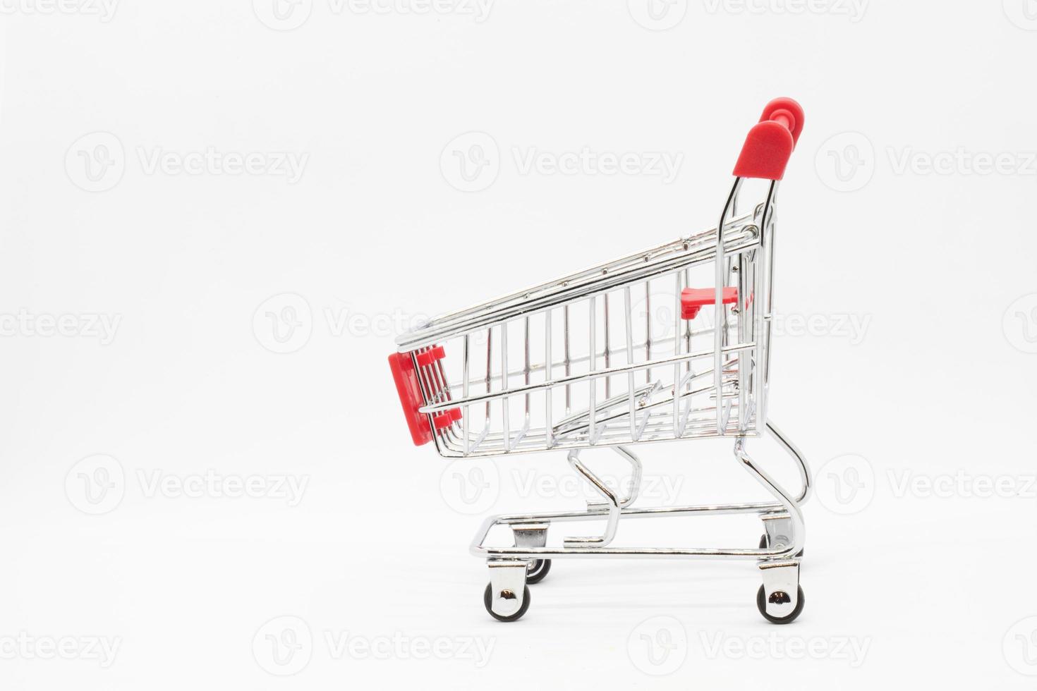 Empty grocery hand cart Shopping cart color red, Mini Supermarket Car Isolated On White Background photo