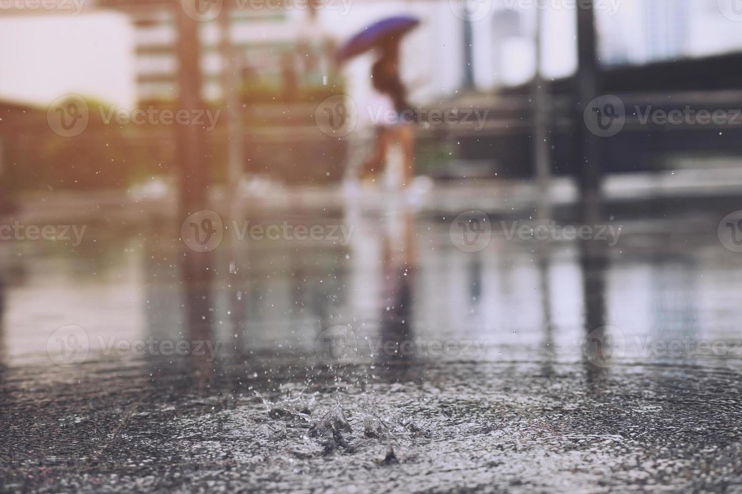 Rain drops in the water heavy on asphalt shade of black shadow and reflection of dark sky in the city. high contrast during autumn photo
