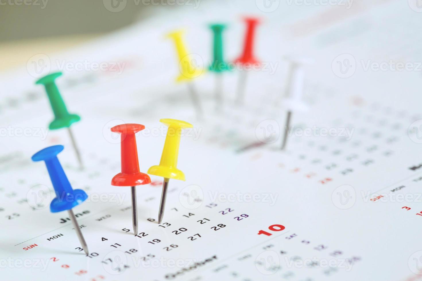 mark the event day with a pin. Thumbtack in calendar concept for busy timeline organize schedule,appointment meeting reminder. planning business meeting or travel holiday planning concept. soft focus photo