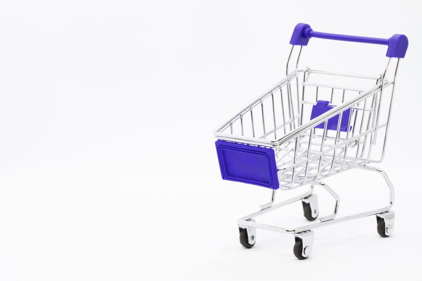 Empty grocery hand cart Shopping cart color red, Mini Supermarket Car Isolated On White Background photo