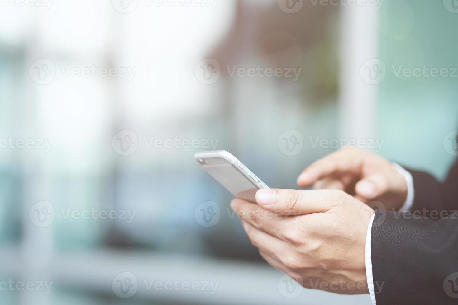 Young male casual wear using on cell phone during rest on sofa. sitting in watching message on mobile phone during break relax. photo