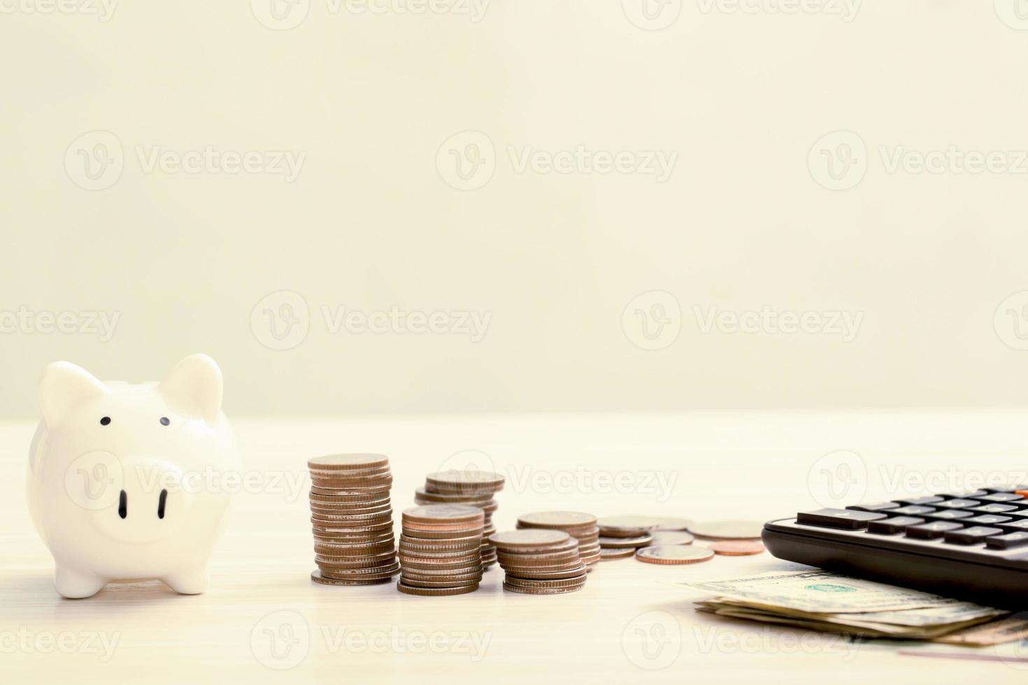 money coins stacked on each other in different positions on the wooden table. photo