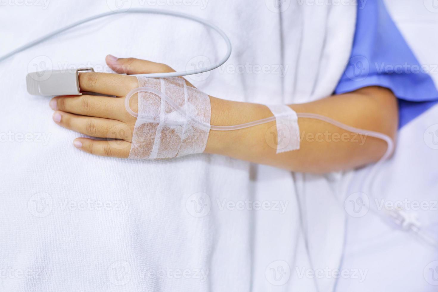 close up focus on the Shake hands of a patient sick encourage encouragement on the bed in hospital ward. photo