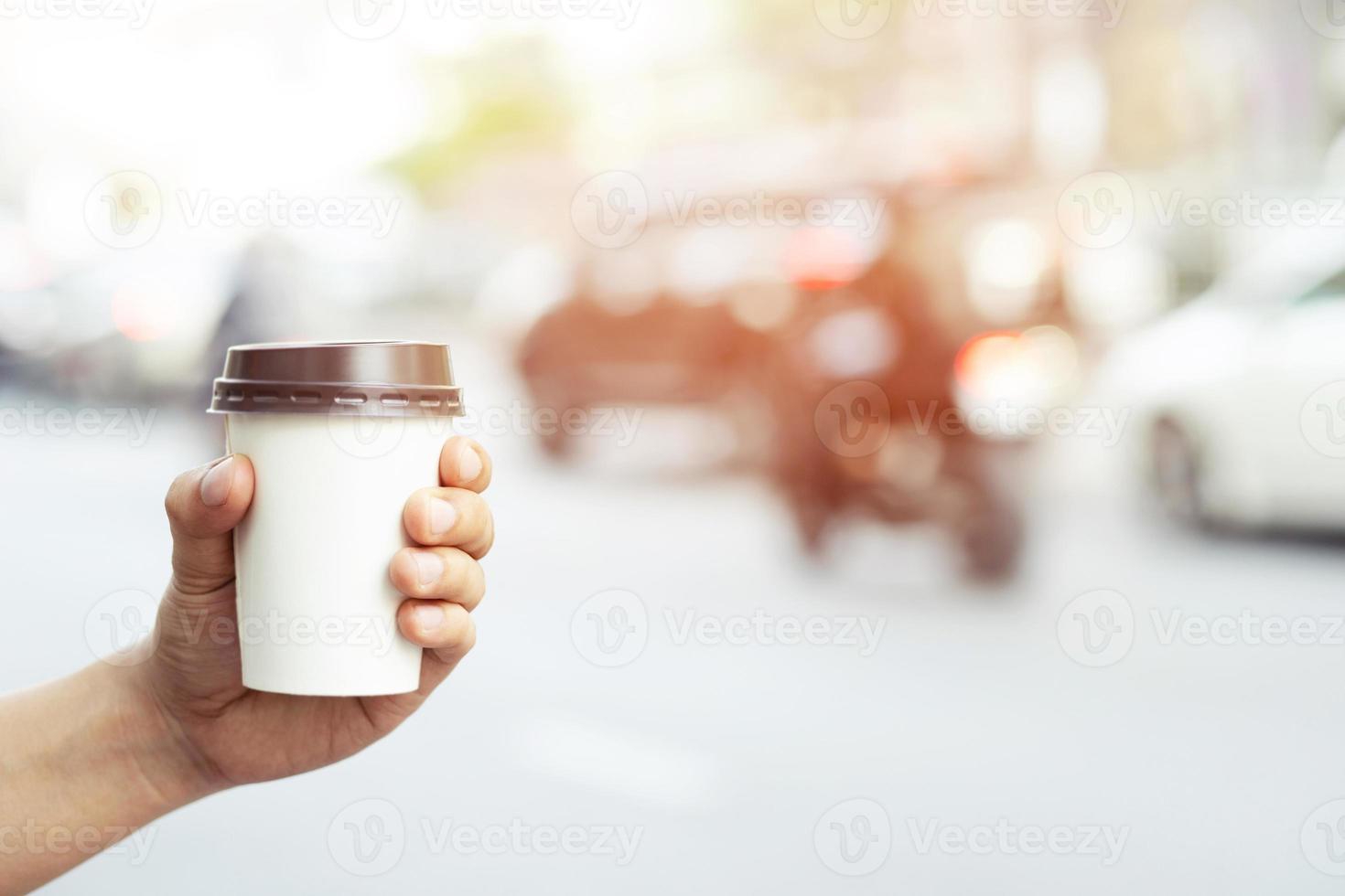 Mockup of male hand holding a Coffee paper cup isolated photo