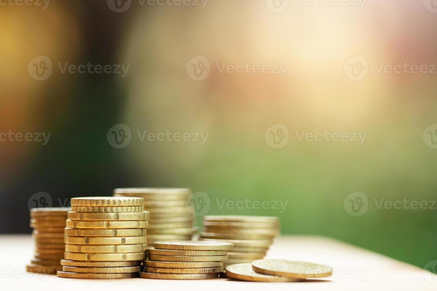 money coins stacked on each other in different positions on the wooden table. Credit financial growing business concept. Saving money. photo