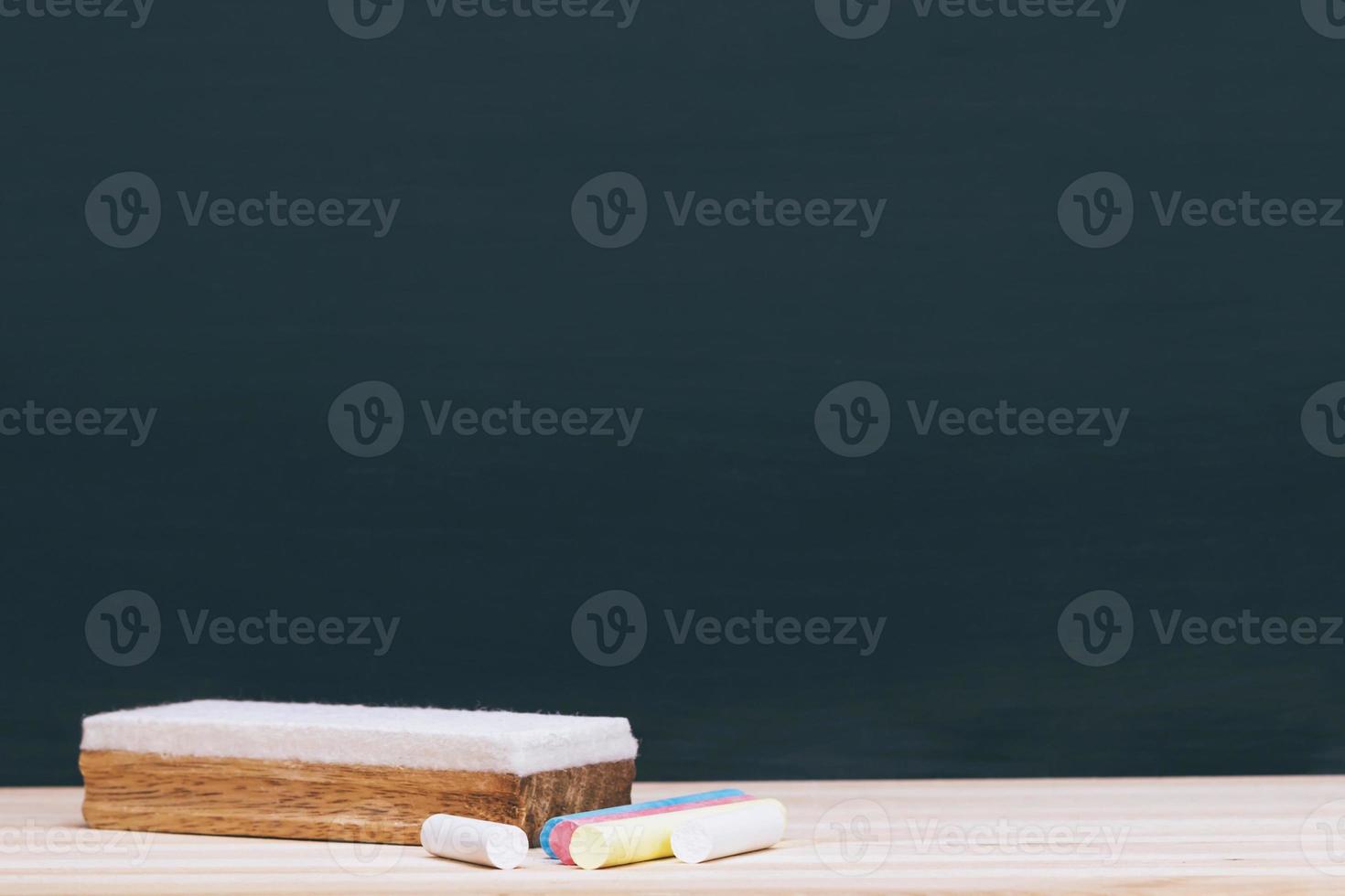 Blank Dark blackboard with Chalk and eraser on the frame for drawing in Classroom. Horizontal composition. copy space empty Chalkboard Background. back to school. education photo