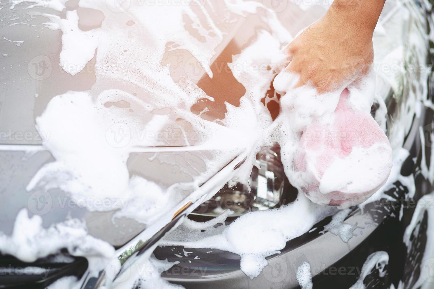 hands hold sponge for washing car photo