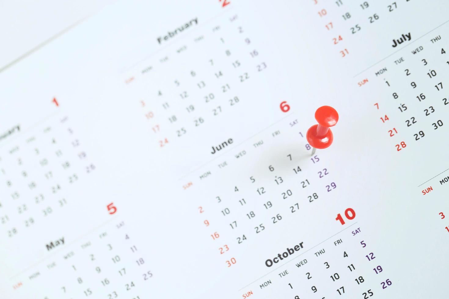 mark the event day with a pin. Thumbtack in calendar concept for busy timeline organize schedule,appointment meeting reminder. planning business meeting or travel holiday planning concept. soft focus photo