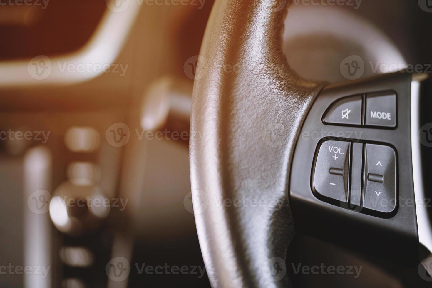 close up Modern black steering wheel with multifunction buttons Integrated stereo controls pushes the for quick control technology in the car. photo