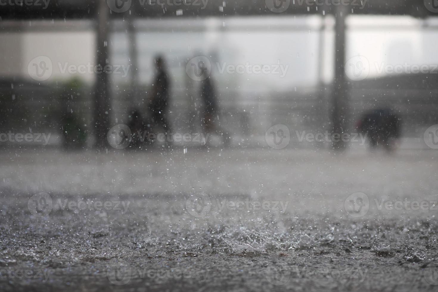 Rain drops in the water heavy on asphalt shade of black shadow and reflection of dark sky in the city. high contrast during autumn photo