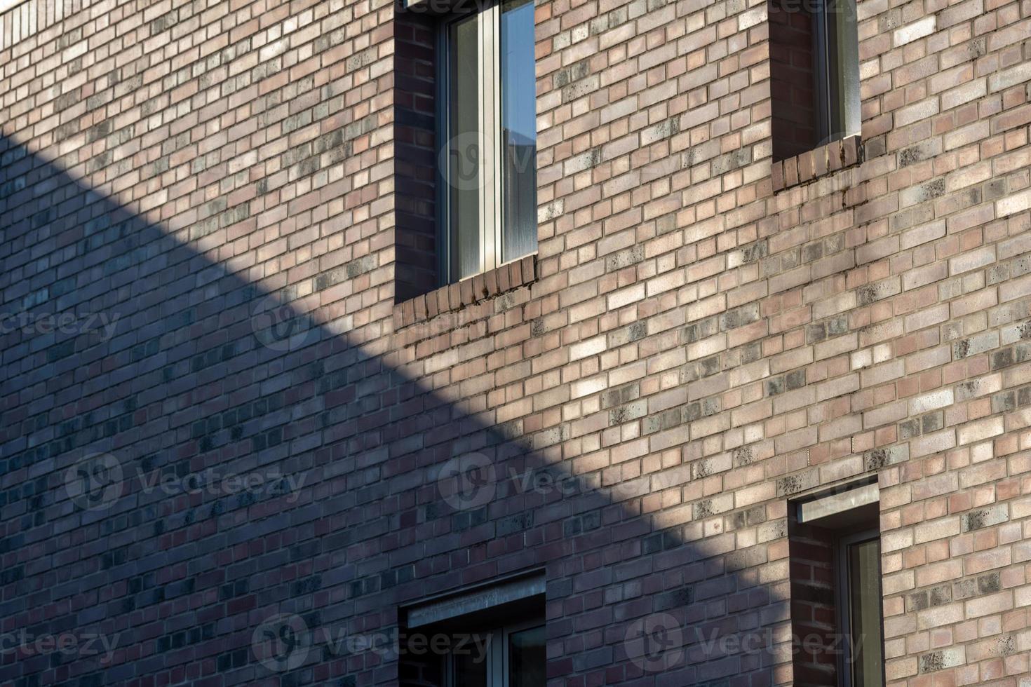 windows of a building in the sun with shadow photo