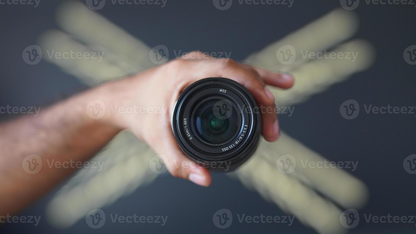 holding lens in hand HD image. photo