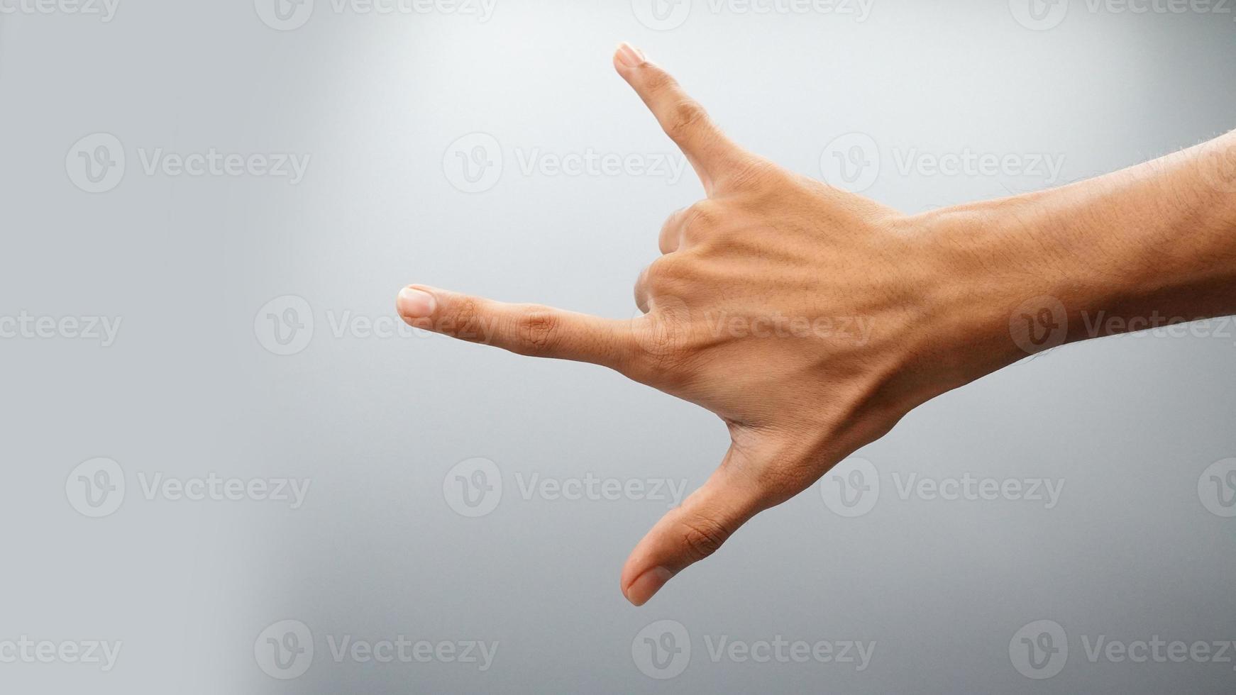 Rock on gesture symbol on white background photo