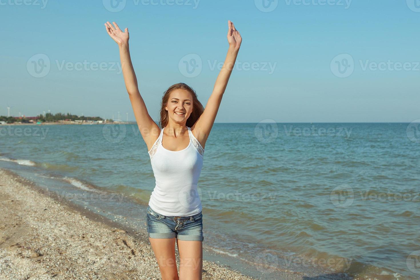 Young cheerful girl on the sea photo