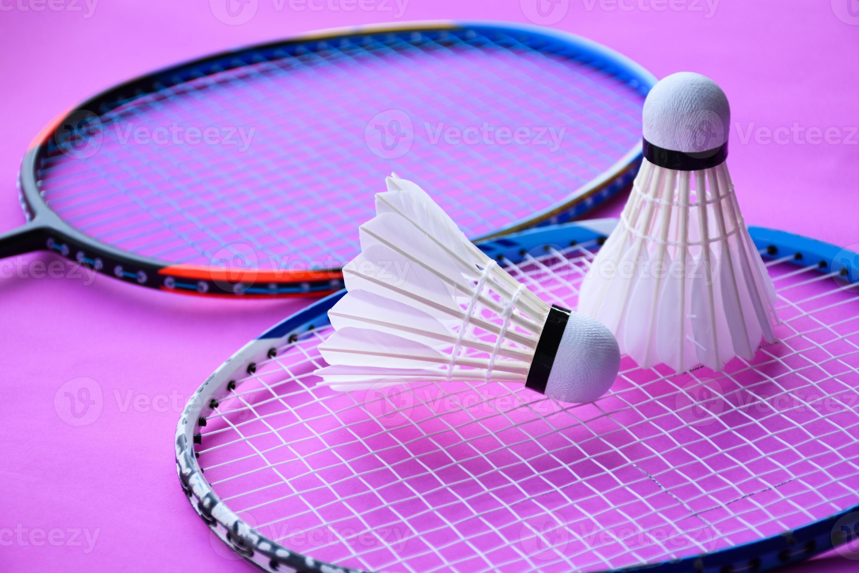 badminton shuttlecock and racket with neon light shading on green floor