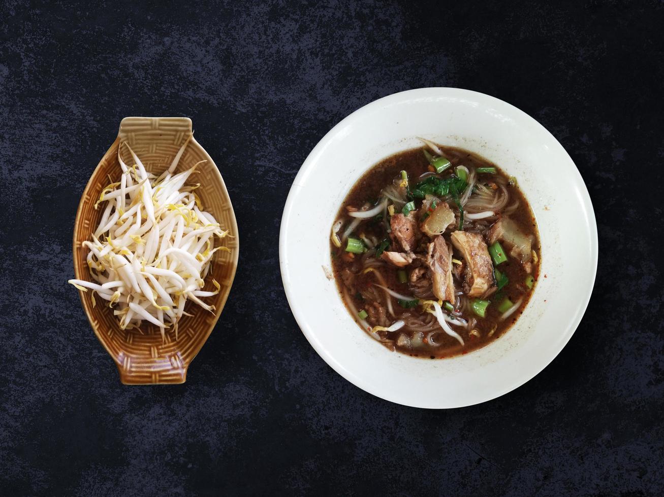 Noodle with beef and bean sprouts, Top view soup meat style on white background, asian food isolated with clipping path photo