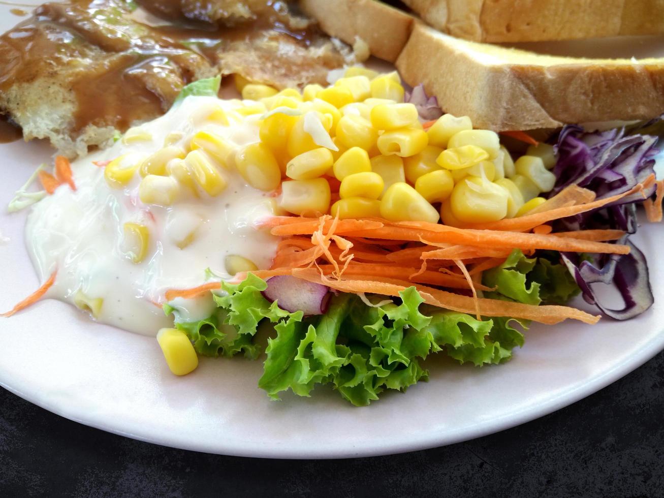 Steak fish with salad and toasted bread on plate, Top view food  sausage and vegetable on background photo