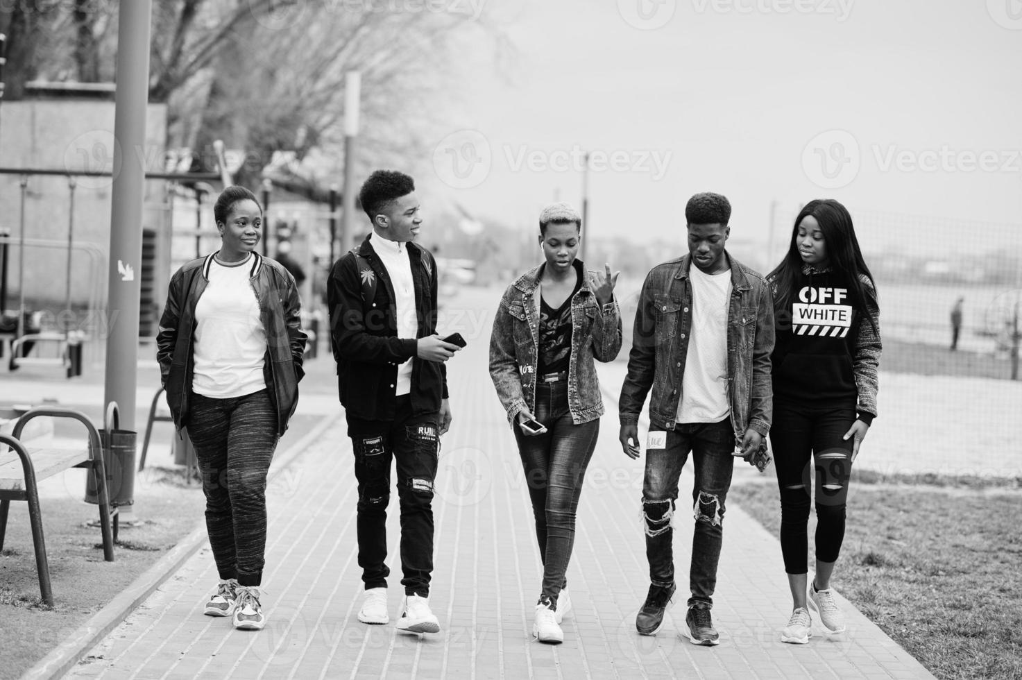 Young millennials african friends walking in city. Happy black people having fun together. Generation Z friendship concept. photo