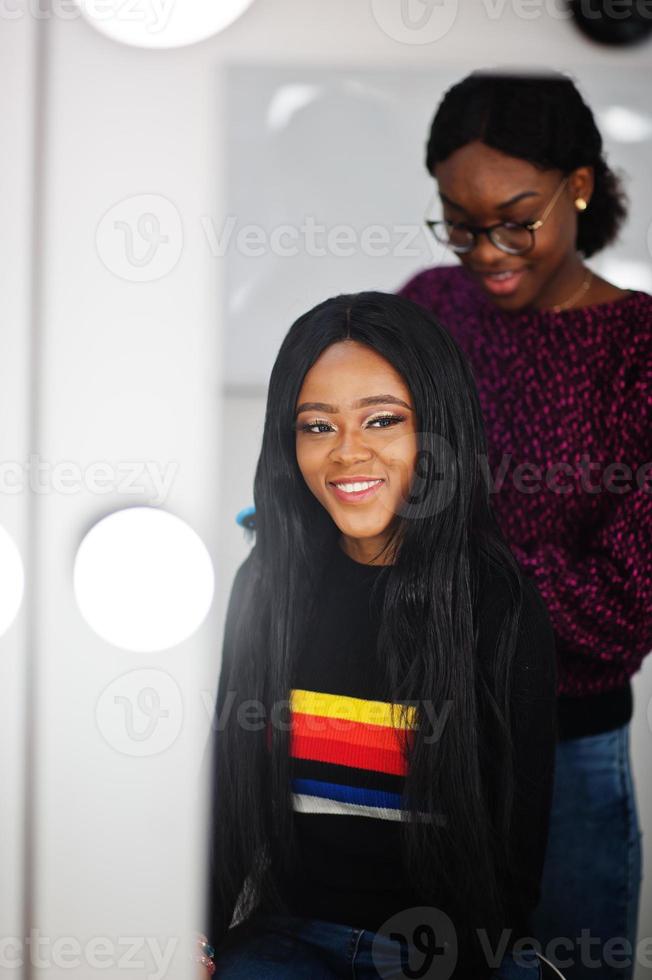 African American woman applying hairdresser or hairstylist at beauty saloon. photo