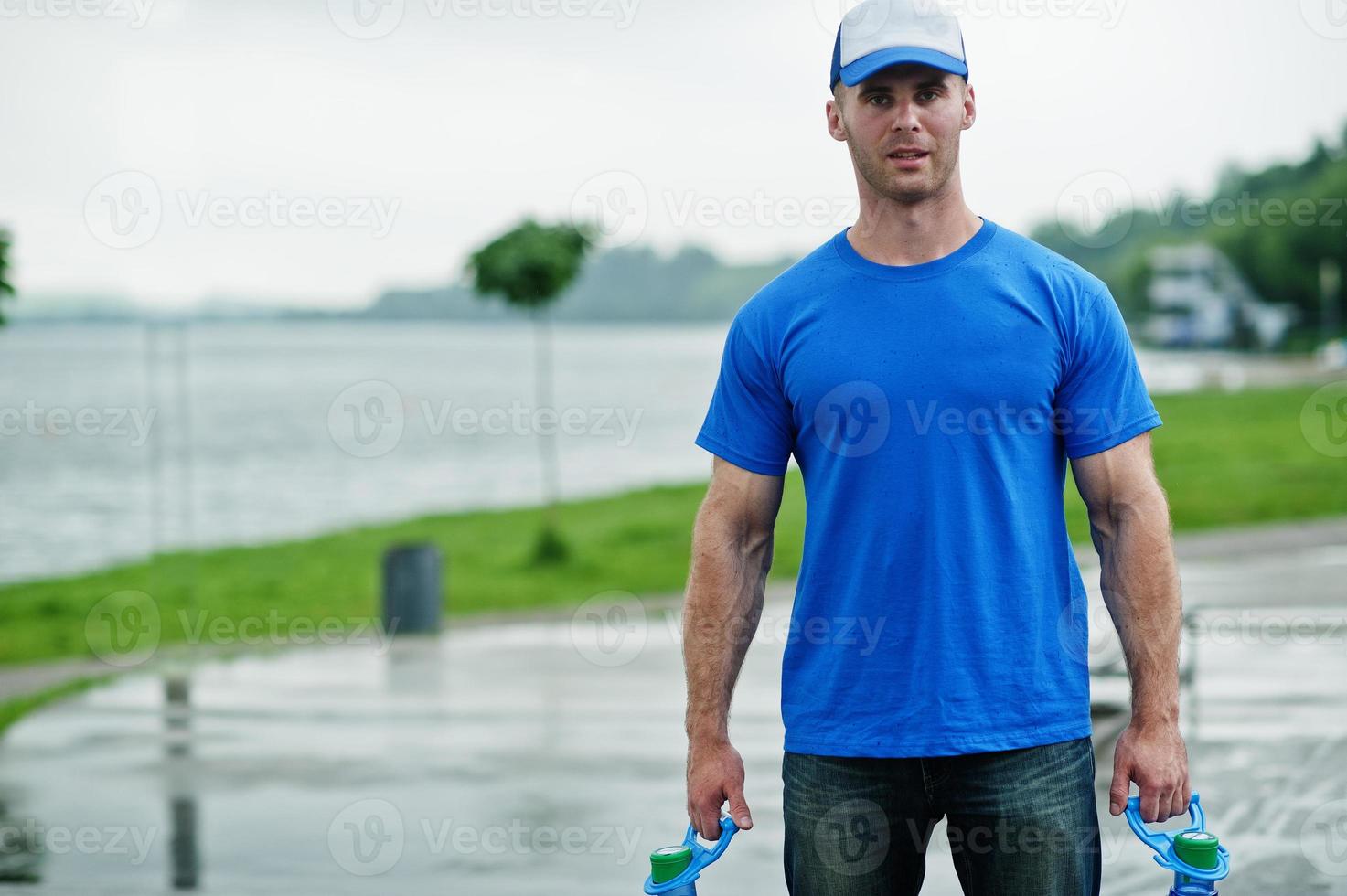 Delivery man with water bottles at hands. photo