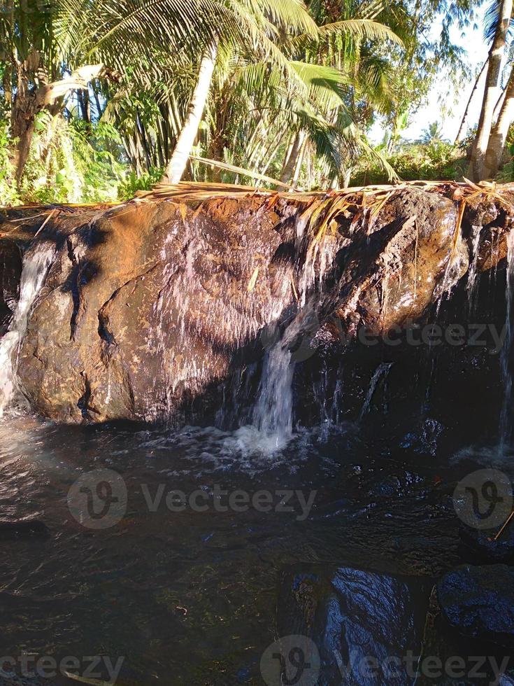river view with beautiful waterfall in sunny morning photo