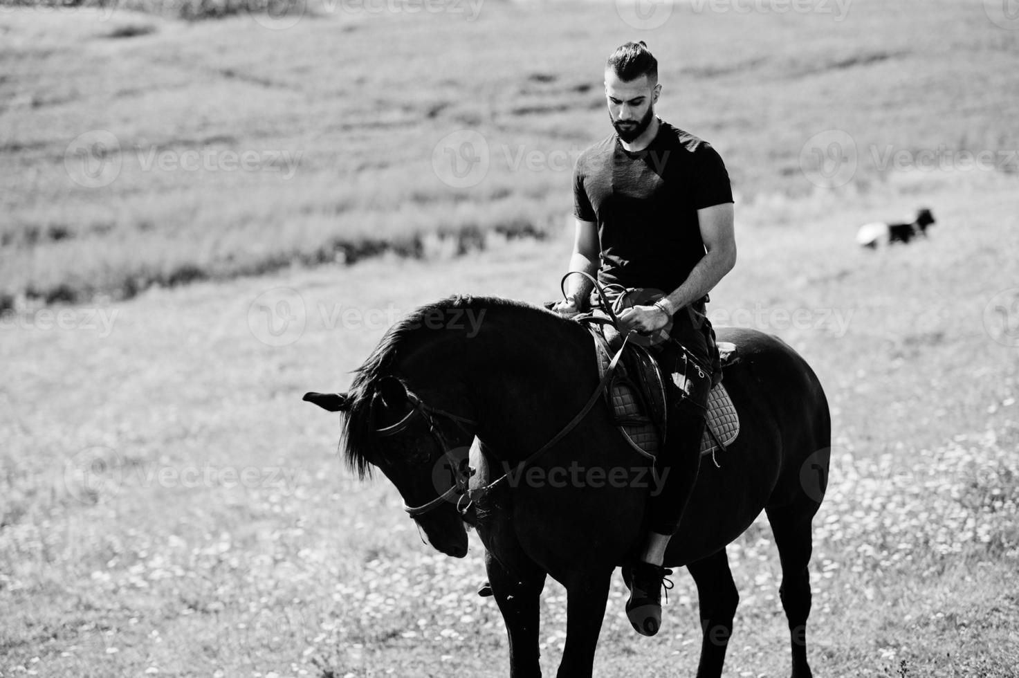 Arab tall beard man wear in black ride arabian horse. photo