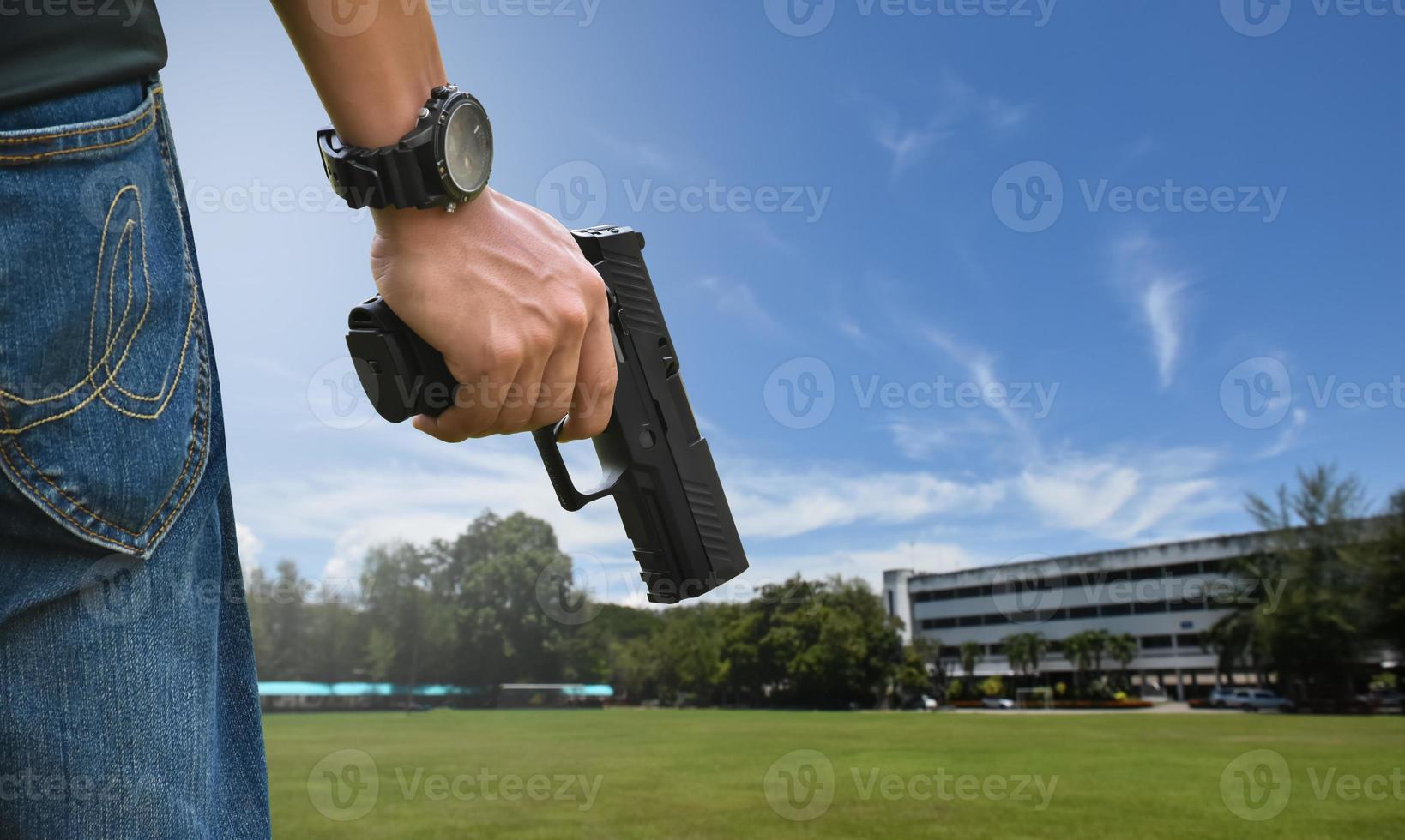 9mm automatic pistol holding in right hand of shooter, concept for security, robbery, gangster, bodyguard around the world. selective focus on pistol. photo