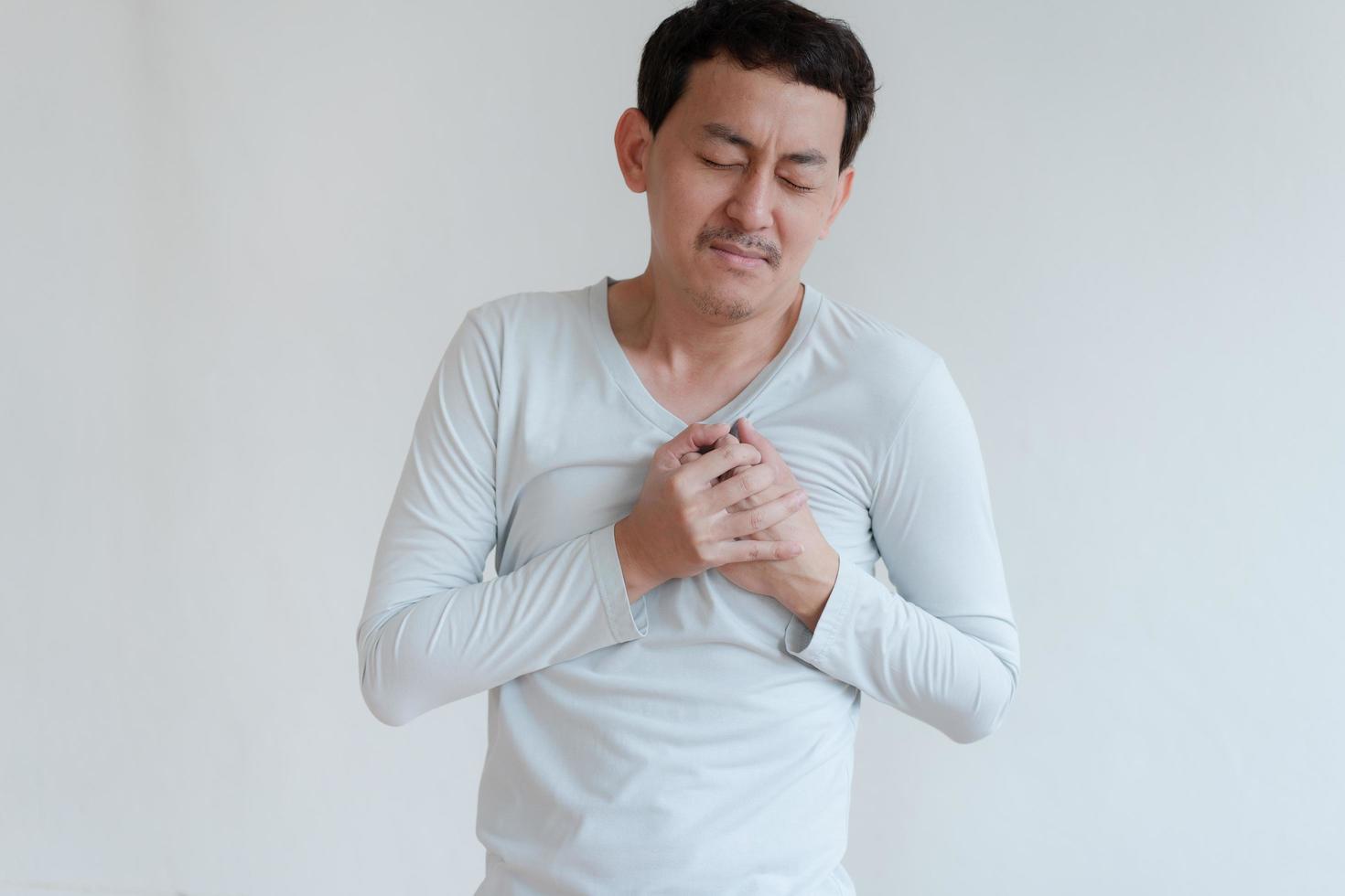 a man touching his heart, with red highlight of heart attack, and others heart disease concept, Heart attack symptom photo