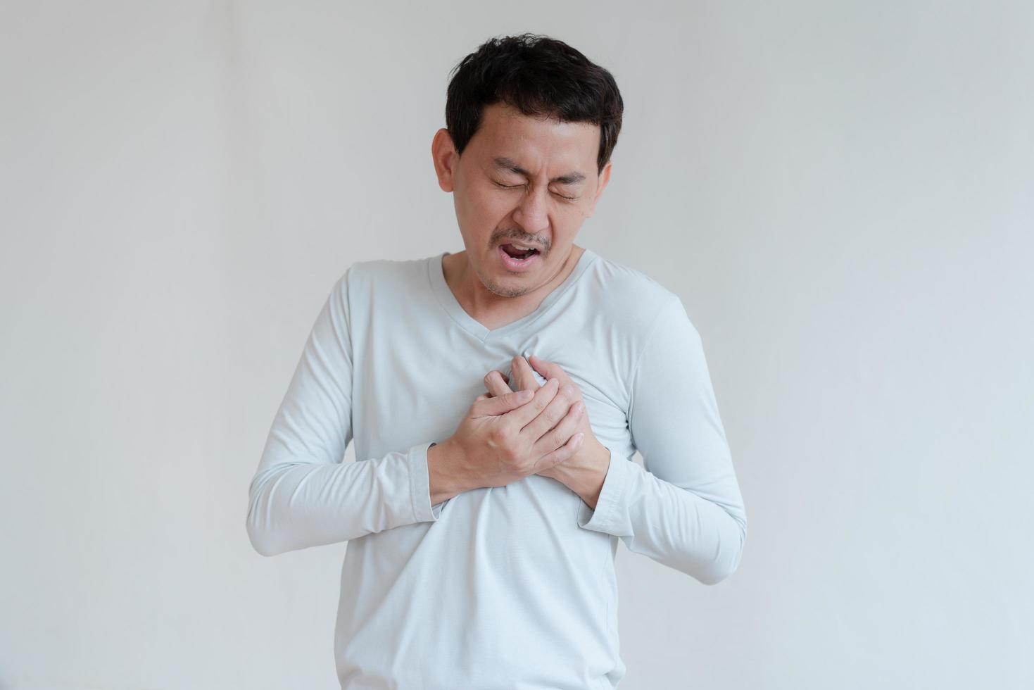 a man touching his heart, with red highlight of heart attack, and others heart disease concept, Heart attack symptom photo