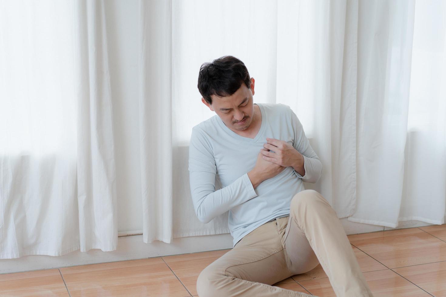 a man touching his heart, with red highlight of heart attack, and others heart disease concept, Heart attack symptom photo