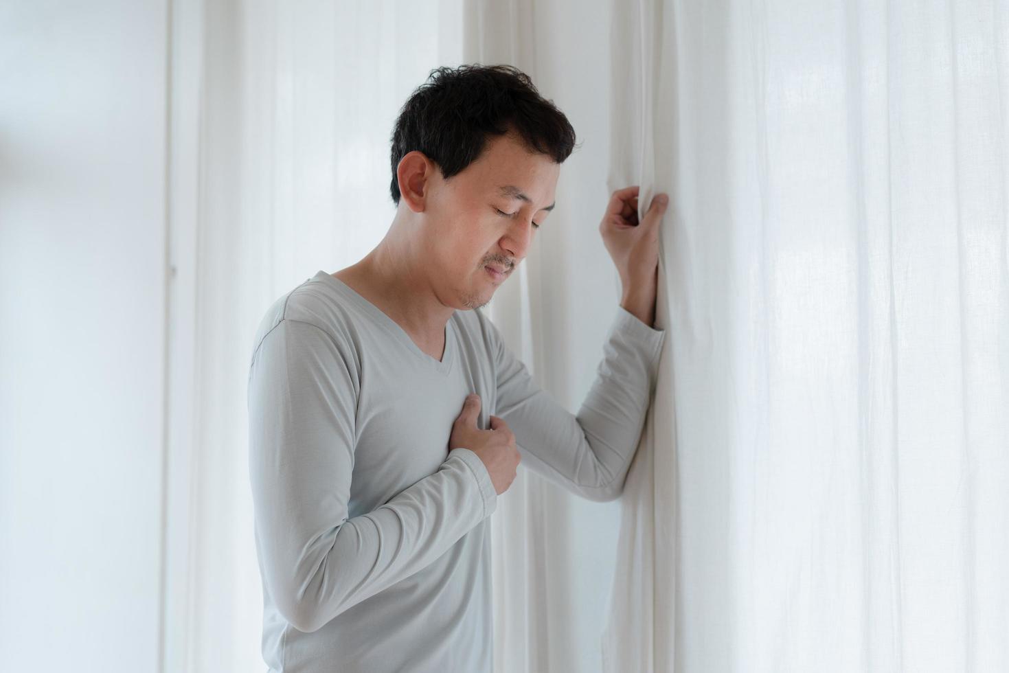 a man touching his heart, with red highlight of heart attack, and others heart disease concept, Heart attack symptom photo