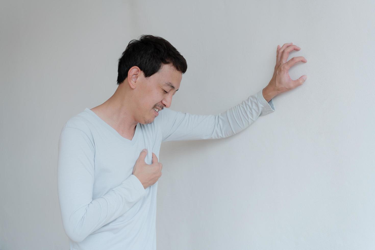 a man touching his heart, with red highlight of heart attack, and others heart disease concept, Heart attack symptom photo