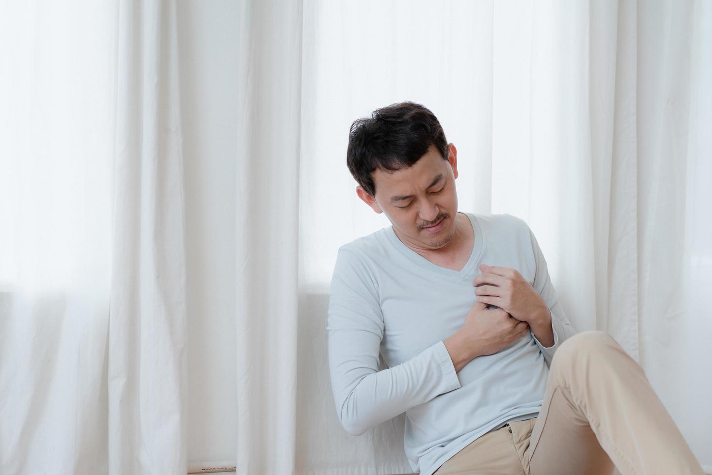 a man touching his heart, with red highlight of heart attack, and others heart disease concept, Heart attack symptom photo