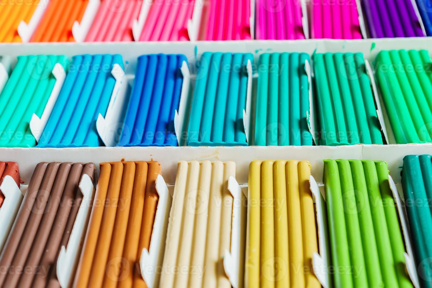 Rainbow colors of modeling clay. Multicolored plasticine bars ina box, background texture photo