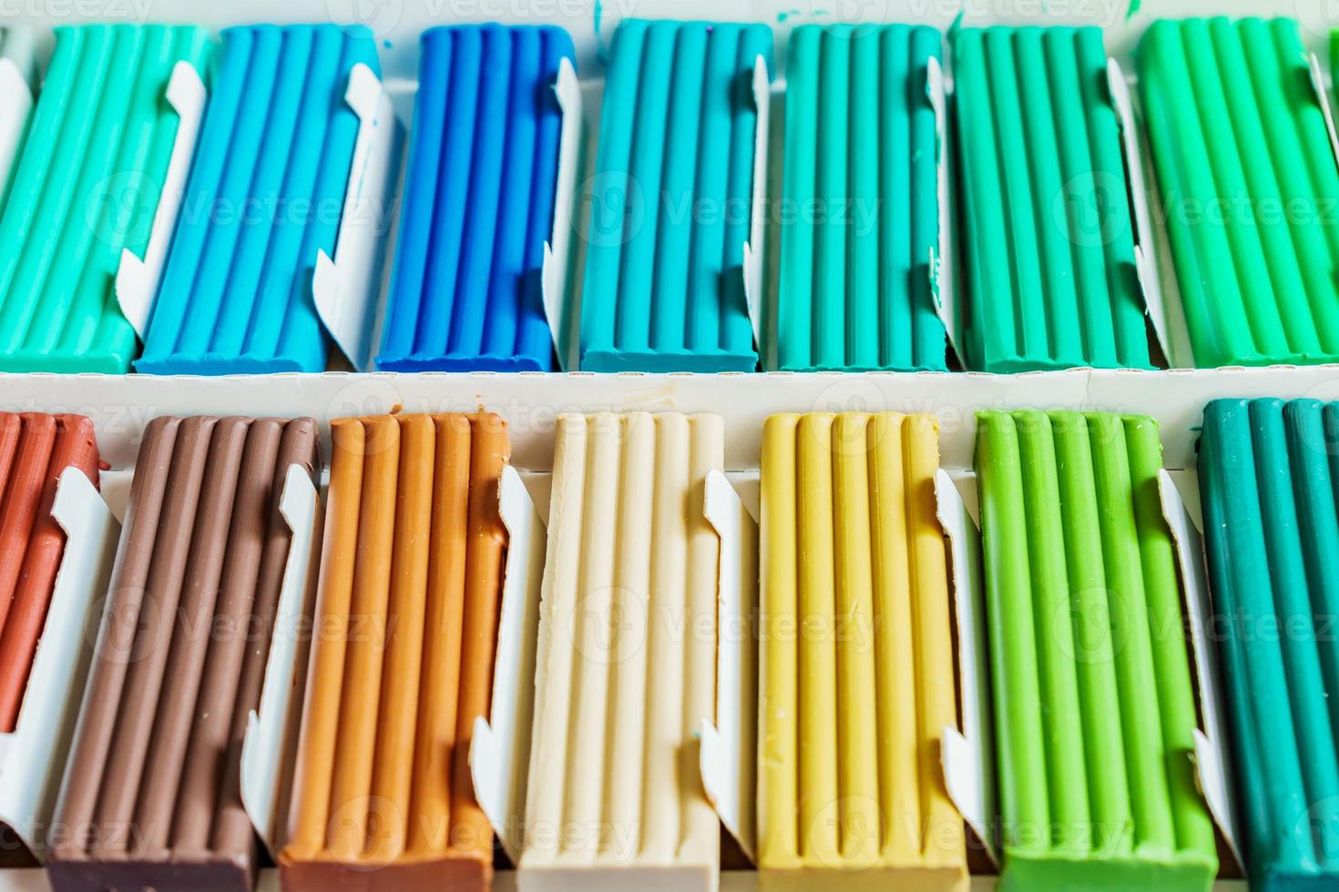 Pastel colors of modeling clay. Multicolored plasticine bars ina box, background texture photo