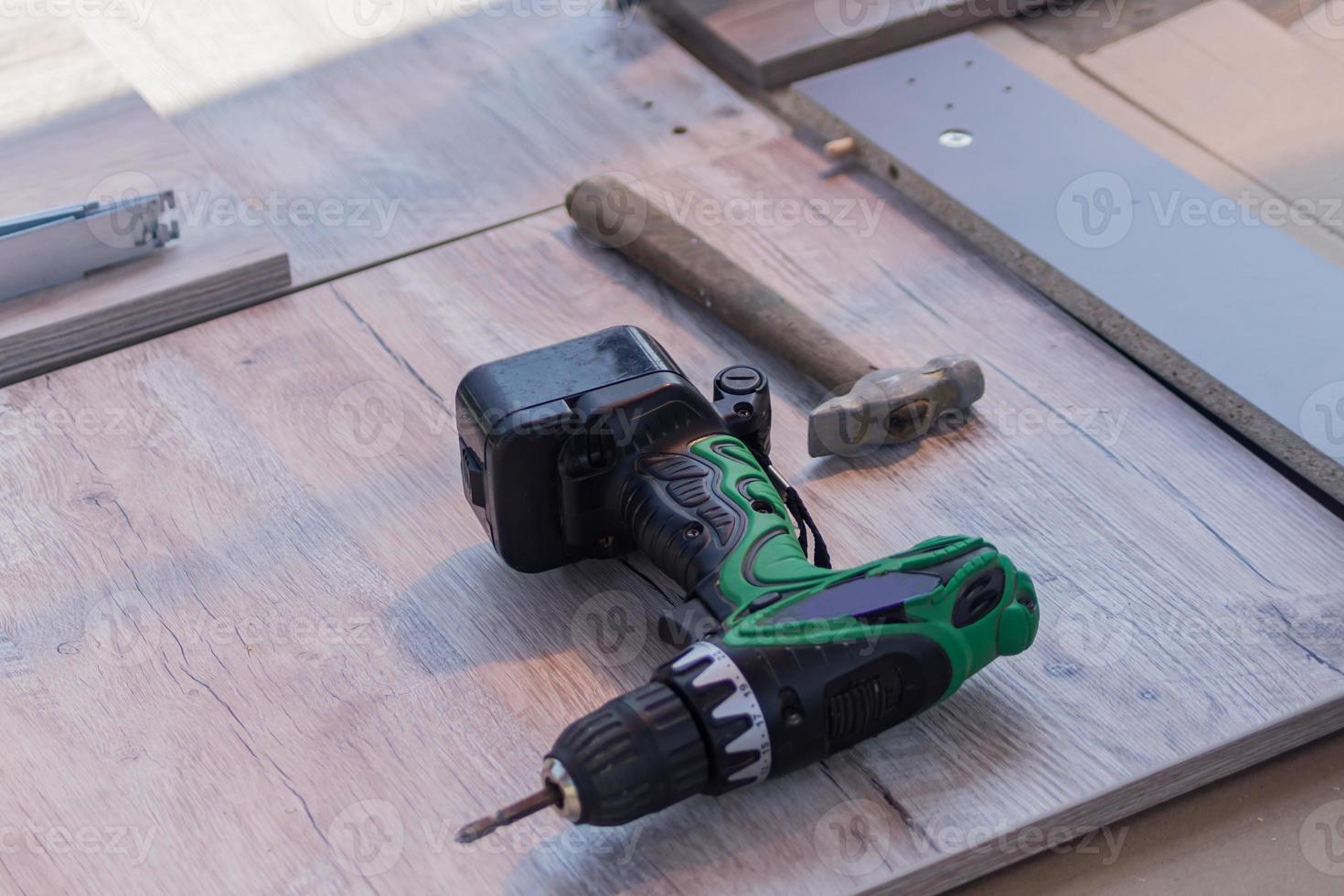 close up of electric screwdriver. Carpenter's work tool on the floor. photo