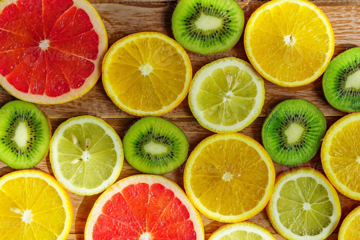 frame with slice of oranges, lemons, kiwi, grapefruit pattern isolated on white background. photo