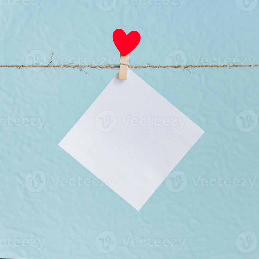 Blank cards on pins with red hearts. Mockup for text and blue background for Valentines Day greetings photo