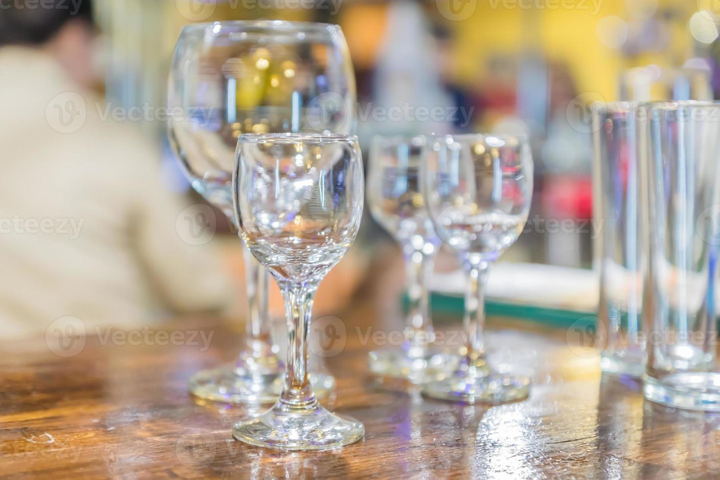 Multiple glassware on the table. Empty clean glass for vine and short drinks at the bar. Selective focus photo