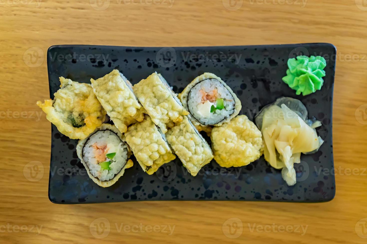 Hot fried Sushi Roll with salmon, eel, calf caviar and cheese. Japanese food. Top view photo