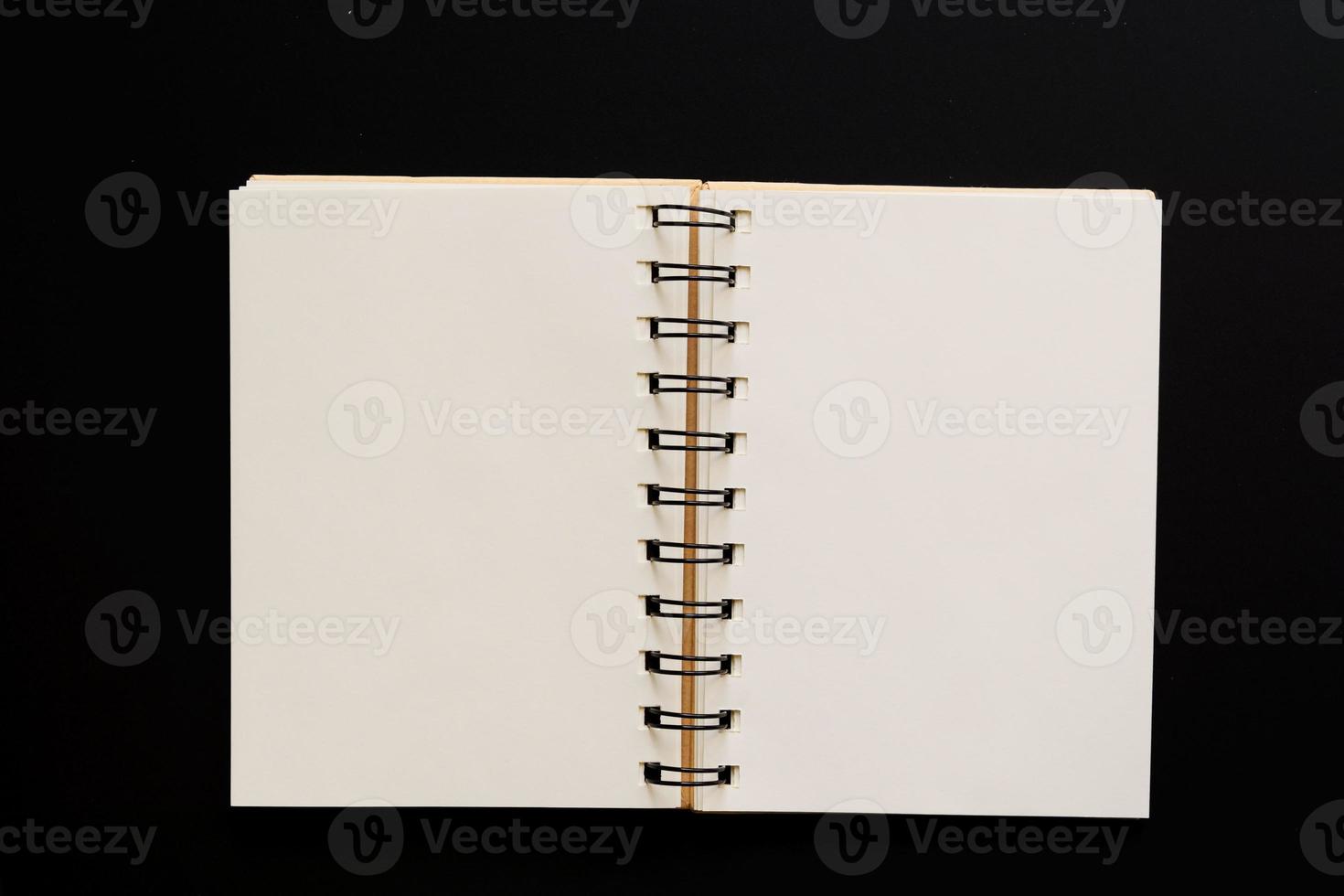 Design concept - Top view of empty kraft notebook on black background. mock up. photo