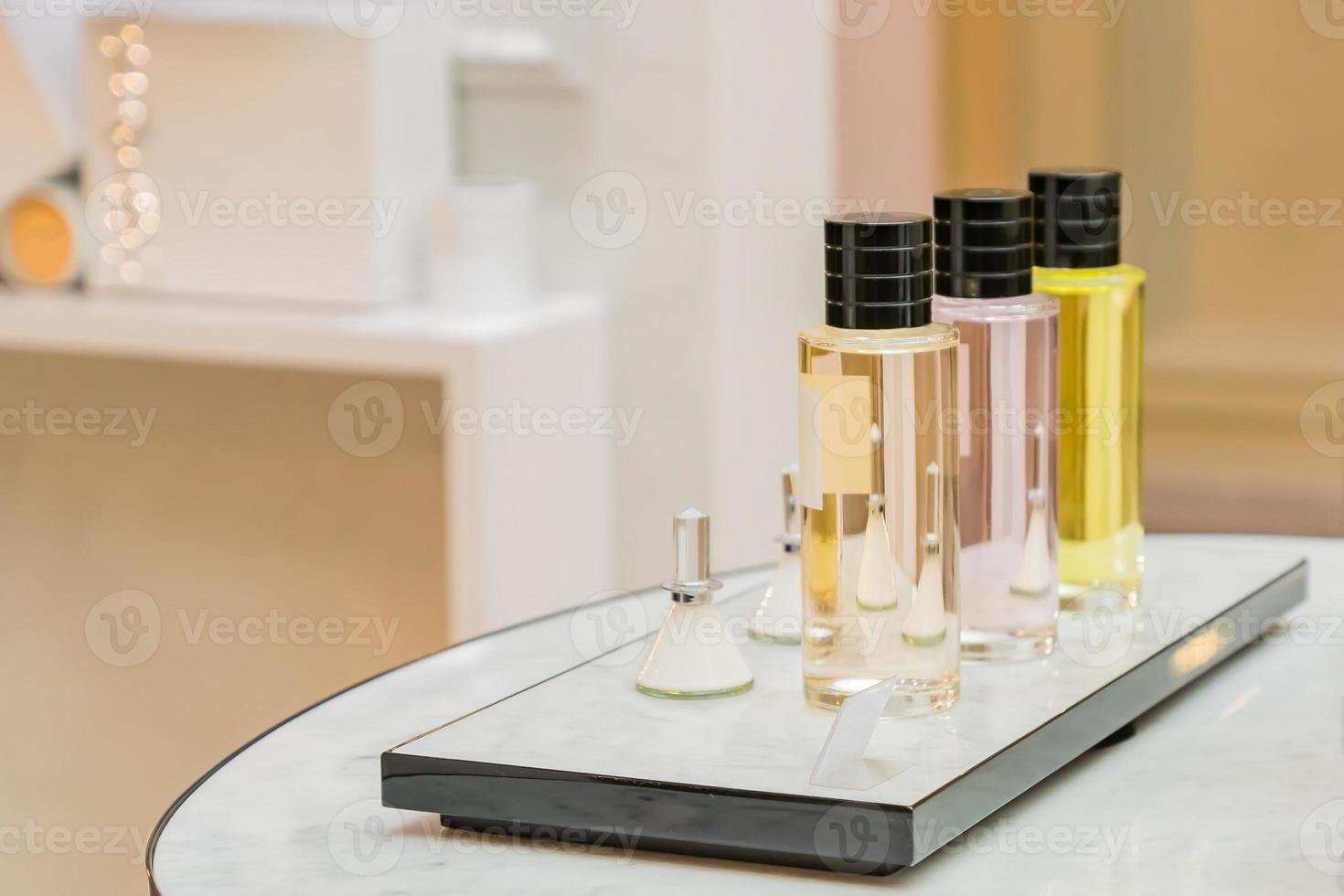 set of colorful perfume bottles in shop window photo