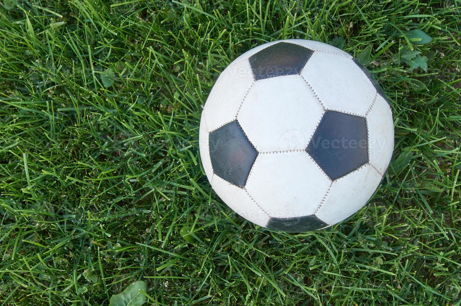 Football ball on green grass. top view with copy space. Sports and recreation concept photo