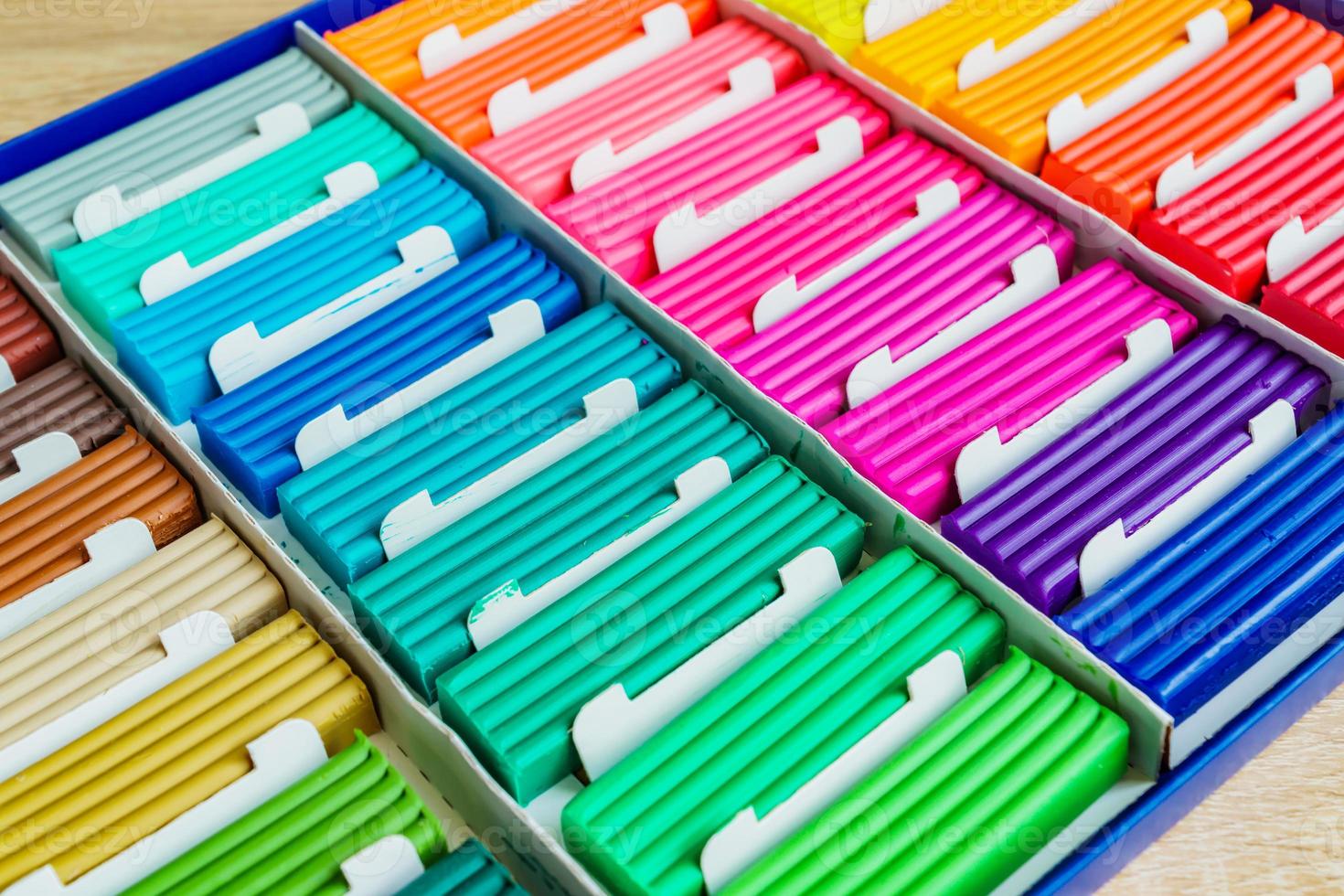 Rainbow colors of modeling clay. Multicolored plasticine bars ina box, background texture photo