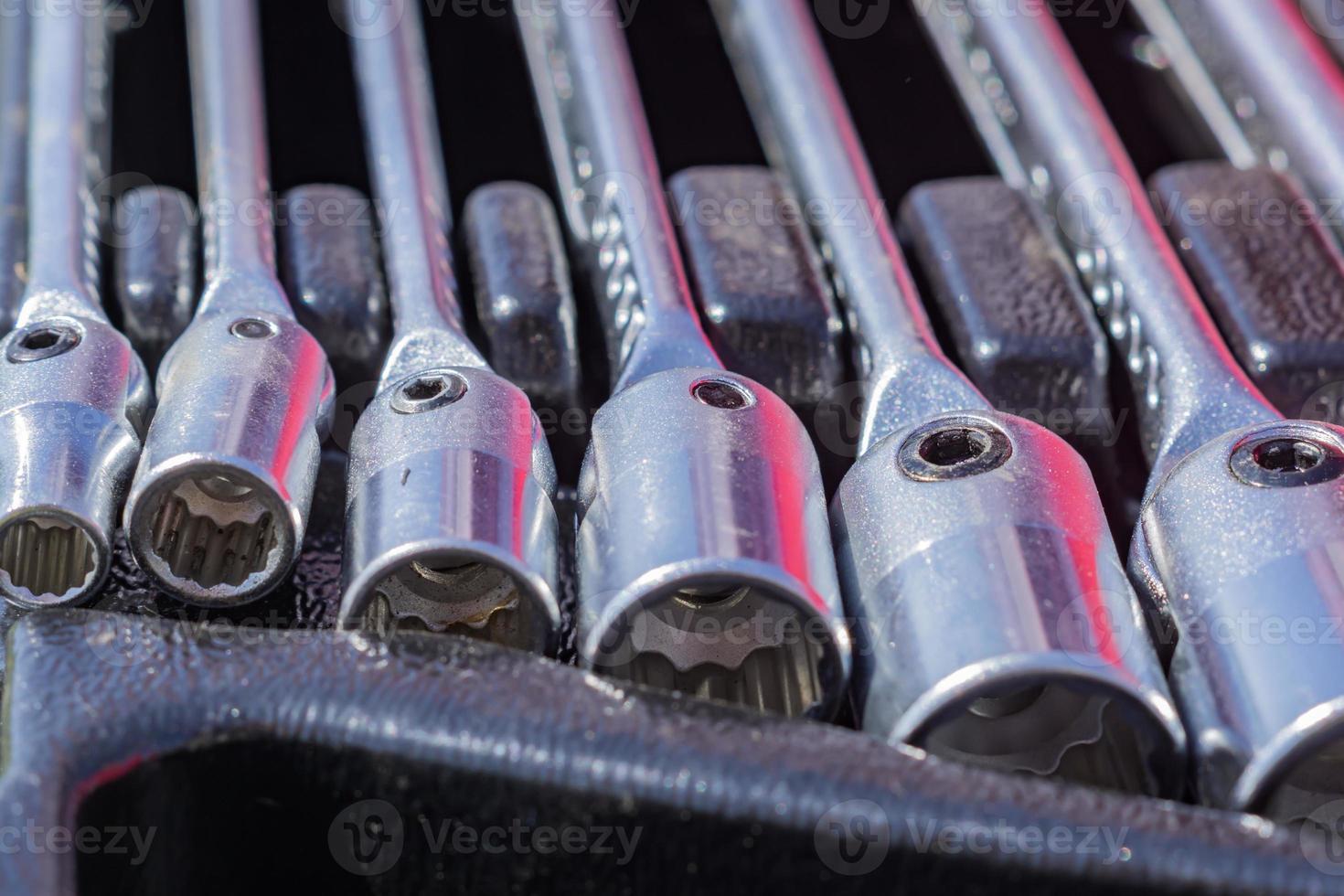 set of socket wrenches in a case,  close up of workers tools, selective focus photo