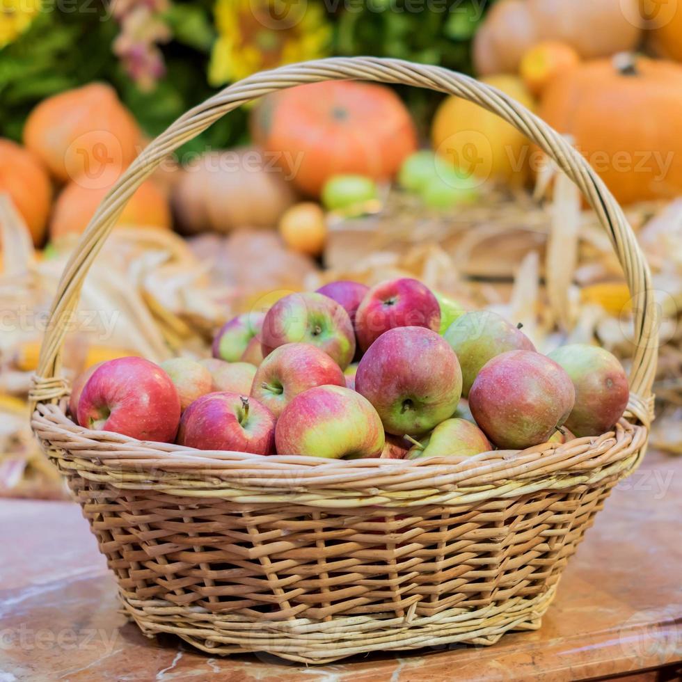 close up of red ripe apples in a basket at the farmer's market photo