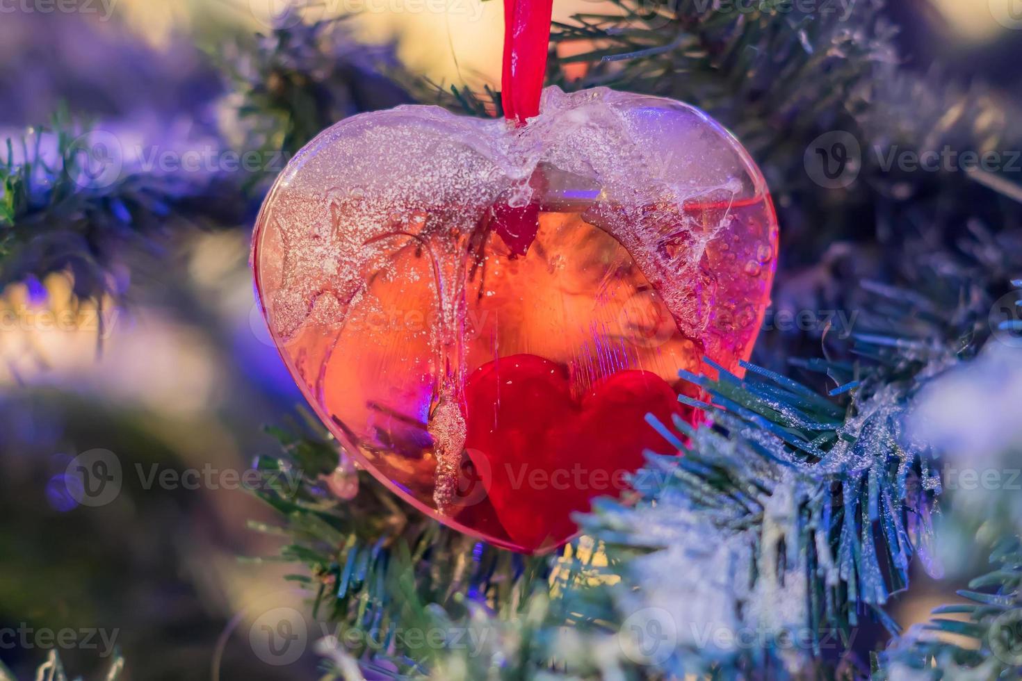 Christmas and New Year holidays background.  Christmas tree decorated with red heart. Celebration concept photo